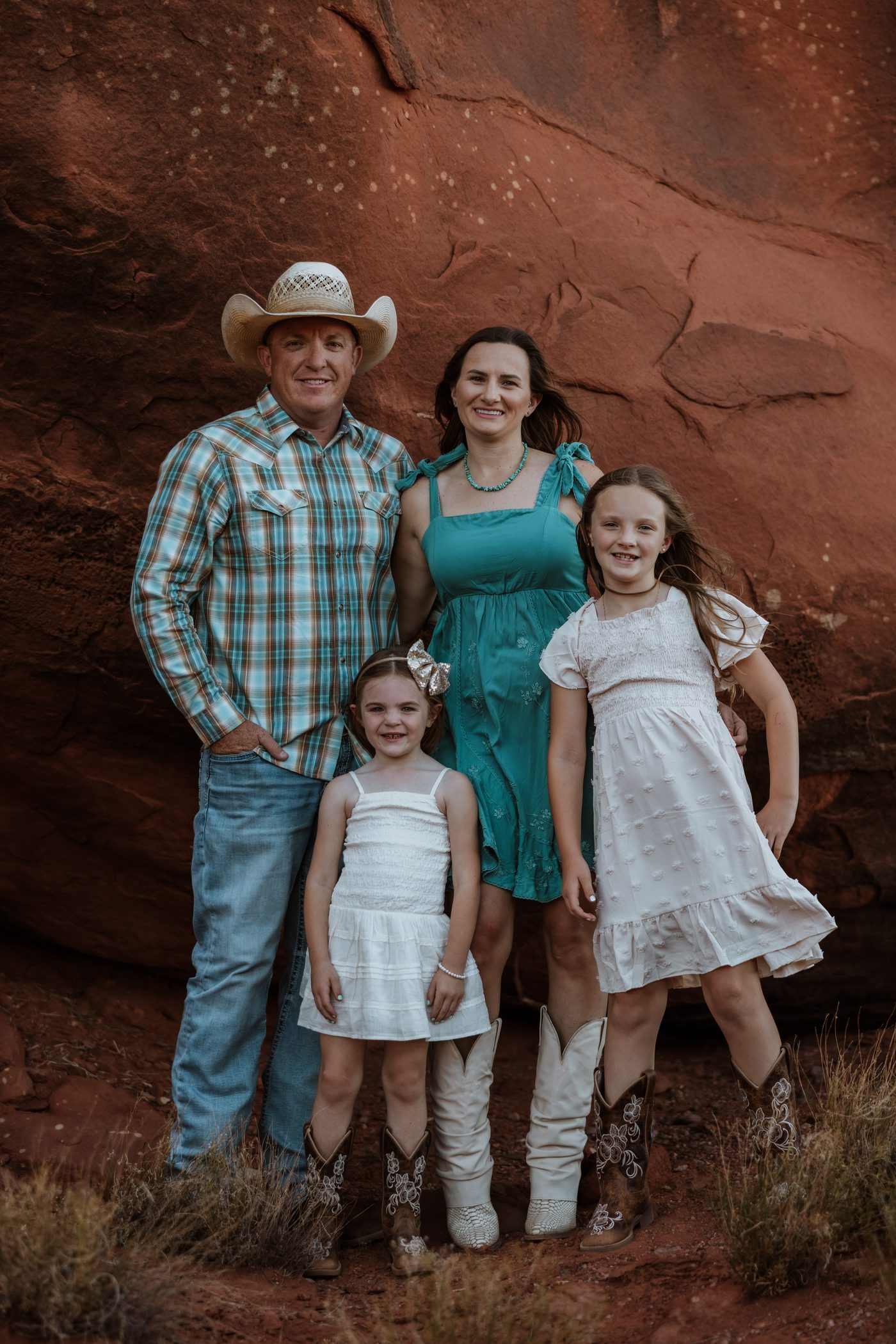 Jamison and Amy Wiggins with their two daughters against the red rock of Grand County, Utah